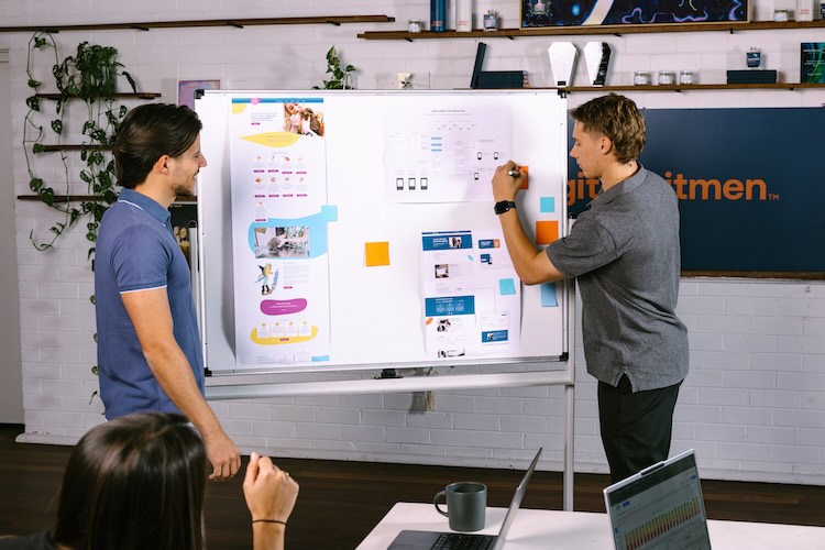 SEO & SEM specialists planning a strategy on a whiteboard