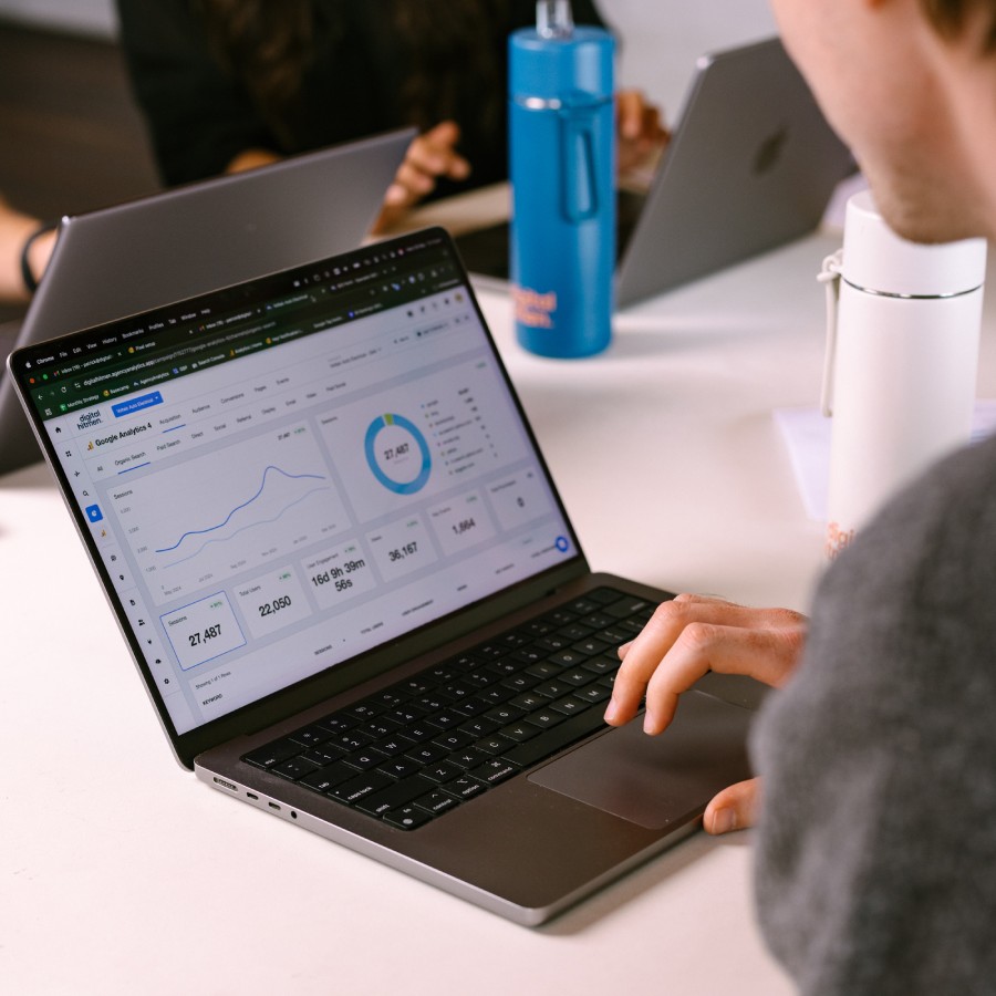 SEO specialist at Digital Hitmen Perth analyzing Google Analytics performance metrics and website traffic data.