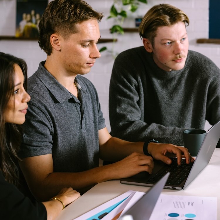 Digital Hitmen Perth SEO team collaborating in a strategy meeting discussing online marketing campaigns.