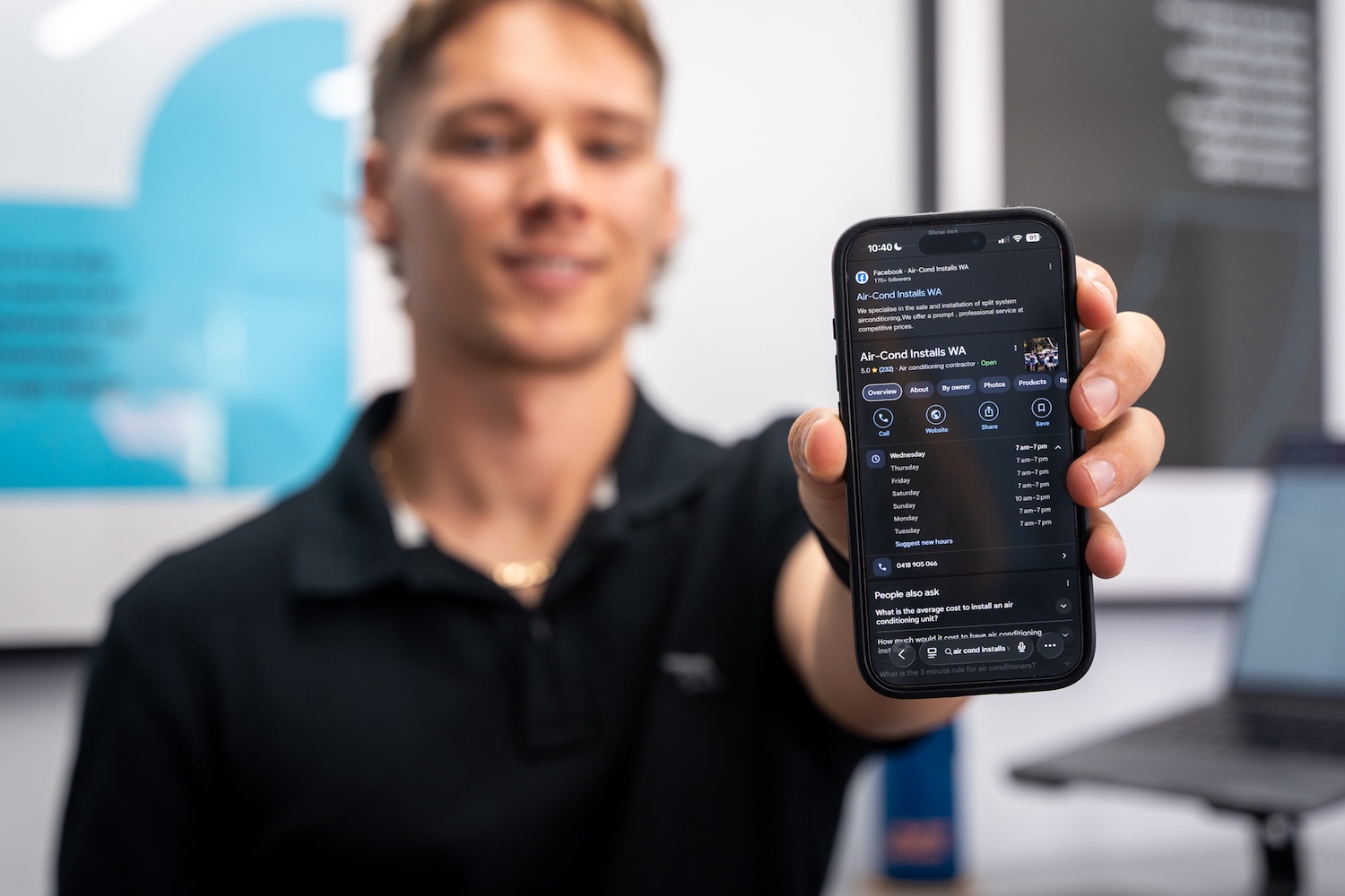 Man holding a phone displaying the Google Business Profile for Air-Cond Installs WA, demonstrating strong local SEO and map listing visibility in Perth.